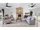 Bright living room features a stone fireplace, ceiling fans and ample seating, perfect for relaxing and entertaining at 21343 Reindeer Rd, Christmas, FL 32709