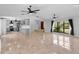 Bright and open floor plan showcasing the living room, kitchen, and staircase with tile flooring at 21343 Reindeer Rd, Christmas, FL 32709