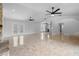 Living room with fireplace, kitchen view, tile flooring, and views of the backyard and lanai at 21343 Reindeer Rd, Christmas, FL 32709