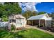 Backyard with a shed and carport on a brick paver pathway, with ample green space at 2305 S Magnolia Ave, Sanford, FL 32771