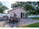 Backyard patio with an outdoor dining set, plants, and partial fence at 2305 S Magnolia Ave, Sanford, FL 32771