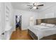 Bright bedroom with wood floors, white walls, and ensuite bathroom at 2305 S Magnolia Ave, Sanford, FL 32771