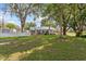 Spacious front yard featuring mature trees and a well-maintained lawn area at 2305 S Magnolia Ave, Sanford, FL 32771