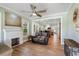Open-concept living room with wood floors, fireplace, and view into the kitchen at 2305 S Magnolia Ave, Sanford, FL 32771