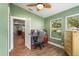 Bright home office with multiple windows and a ceiling fan for added comfort at 2305 S Magnolia Ave, Sanford, FL 32771