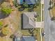 Overhead shot of a residential property featuring a well kept lawn, long driveway, and neighborhood street access at 23533 Valderama Ln, Sorrento, FL 32776