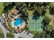 Aerial view of community pool, tennis courts, landscaping, and gathering pavilions at 23533 Valderama Ln, Sorrento, FL 32776