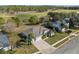 Overhead view of a charming home with manicured landscaping, a long driveway, and picturesque golf course backdrop at 23533 Valderama Ln, Sorrento, FL 32776