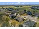 Aerial view of a golf course neighborhood, featuring mature trees and homes with swimming pools in their backyard at 23533 Valderama Ln, Sorrento, FL 32776