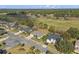 Aerial view of a single-Gathering home within a residential area that is near a golf course and lots of trees at 23533 Valderama Ln, Sorrento, FL 32776