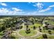Aerial view of the community with manicured lawns, lush landscaping, and neatly arranged homes at 23533 Valderama Ln, Sorrento, FL 32776