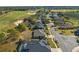 Aerial view of a golf course neighborhood, featuring many single-Gathering homes and mature trees on the lots at 23533 Valderama Ln, Sorrento, FL 32776