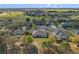 Aerial view of a residential neighborhood and golf course, with homes that have mature trees and well-manicured lawns at 23533 Valderama Ln, Sorrento, FL 32776