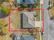 Aerial view of a single-Gathering home featuring a driveway and spacious front and back yard surrounded by mature trees at 23533 Valderama Ln, Sorrento, FL 32776