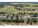 Aerial view of the community featuring lush greenery, a golf course, and beautiful homes at 23533 Valderama Ln, Sorrento, FL 32776