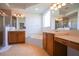 Luxurious bathroom featuring dual vanities, a soaking tub, and a separate glass-enclosed shower at 23533 Valderama Ln, Sorrento, FL 32776