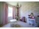 Charming bedroom with pink decor, a play kitchen, and a round table set at 23533 Valderama Ln, Sorrento, FL 32776
