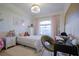 Cozy bedroom featuring a plush bed, soft lighting, and a dedicated workspace with a comfortable chair at 23533 Valderama Ln, Sorrento, FL 32776