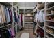 Organized walk-in closet with custom shelving, drawers, and plenty of storage space for clothes and accessories at 23533 Valderama Ln, Sorrento, FL 32776