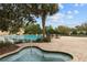 Relaxing community pool and spa area, with comfortable seating under a large palm tree at 23533 Valderama Ln, Sorrento, FL 32776