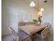 Elegant dining room with a light wood table, woven chairs, and modern decor, perfect for gatherings at 23533 Valderama Ln, Sorrento, FL 32776