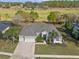 Picturesque home with well maintained landscaping, a brick driveway, and golf course views in the background at 23533 Valderama Ln, Sorrento, FL 32776