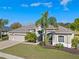 Well maintained home showcasing mature palm trees, manicured lawn, and an inviting entrance at 23533 Valderama Ln, Sorrento, FL 32776