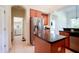 Spacious kitchen featuring modern appliances, a central island, and convenient access to the laundry room at 23533 Valderama Ln, Sorrento, FL 32776