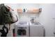 Functional laundry room with modern washer and dryer units, shelving, and organized storage solutions at 23533 Valderama Ln, Sorrento, FL 32776