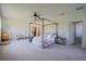 Large main bedroom featuring a stylish four-poster bed frame, neutral colors, and a ceiling fan at 23533 Valderama Ln, Sorrento, FL 32776