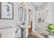 This bathroom offers a pedestal sink, framed seahorse, and a glass enclosed walk-in shower at 240 Promenade Cir, Lake Mary, FL 32746