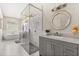 Bright bathroom featuring a glass shower, soaking tub, and granite vanity at 240 Promenade Cir, Lake Mary, FL 32746