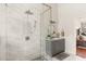 Bright bathroom featuring a glass shower, granite vanity, decorative mirror and great natural lighting at 240 Promenade Cir, Lake Mary, FL 32746