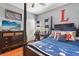 Stylized bedroom with hardwood floors, closet, dresser and large bed with a desk at 240 Promenade Cir, Lake Mary, FL 32746