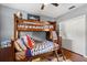 Charming bedroom featuring a wooden bunk bed with shark-themed bedding and a ceiling fan at 240 Promenade Cir, Lake Mary, FL 32746