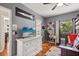 Comfortable bedroom featuring a desk, flat screen tv, and nautical themed decor at 240 Promenade Cir, Lake Mary, FL 32746