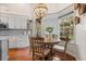 Eat-in kitchen and breakfast nook featuring a modern chandelier and views of the outdoors at 240 Promenade Cir, Lake Mary, FL 32746