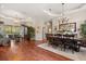 Open concept dining room showcasing hardwood floors and a large living area at 240 Promenade Cir, Lake Mary, FL 32746