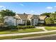 Stunning single-story home with mature landscaping and a manicured lawn under a blue sky at 240 Promenade Cir, Lake Mary, FL 32746