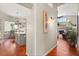 Open-concept home featuring a hallway with wood floors and a view of the living spaces at 240 Promenade Cir, Lake Mary, FL 32746