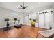 Spacious home gym complete with treadmill, exercise bike, wood floors, and built in cabinets and desk at 240 Promenade Cir, Lake Mary, FL 32746