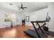 Bright home gym featuring an exercise treadmill and bike on hardwood floors with neutral walls at 240 Promenade Cir, Lake Mary, FL 32746