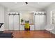 Bright home gym with hard wood floors, built in shelving, and desk space with a vaulted ceiling at 240 Promenade Cir, Lake Mary, FL 32746