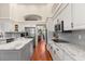 Modern kitchen features white cabinets, gray subway tile backsplash, and stainless steel appliances at 240 Promenade Cir, Lake Mary, FL 32746
