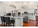 Stylish kitchen with granite island, white cabinets, and stainless steel appliances at 240 Promenade Cir, Lake Mary, FL 32746