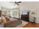 Comfortable bedroom featuring a large dresser, plush bedding, and backyard views at 240 Promenade Cir, Lake Mary, FL 32746