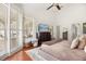 Spacious bedroom with shuttered windows, a ceiling fan, and closet space for ample storage at 240 Promenade Cir, Lake Mary, FL 32746