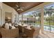 Relaxing screened-in patio features comfortable seating and a ceiling fan overlooking the pool area at 240 Promenade Cir, Lake Mary, FL 32746