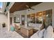 Relaxing covered patio has comfortable seating and an area rug, creating a cozy outdoor living space at 240 Promenade Cir, Lake Mary, FL 32746
