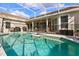 Sparkling in-ground pool with screened enclosure, safety fence, and outdoor seating invites relaxation and fun at 240 Promenade Cir, Lake Mary, FL 32746
